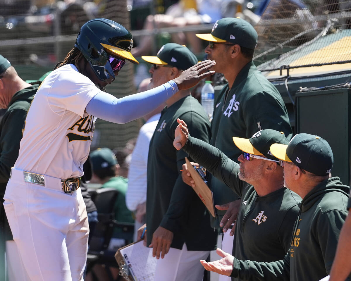 Oakland Athletics' Lawrence Butler, left, celebrates with manager Mark Kotsay, second from righ ...