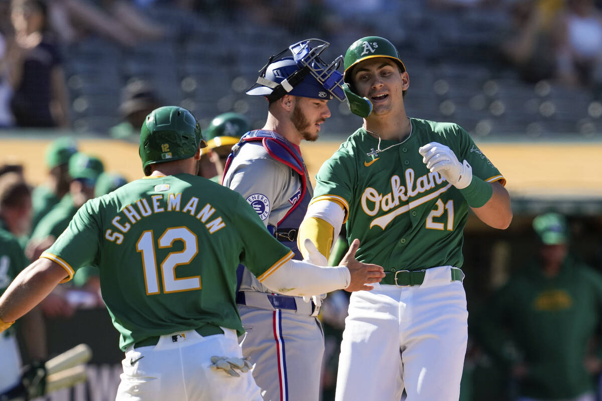 Oakland Athletics' Tyler Soderstrom, right, celebrates with Max Schuemann, left, after hitting ...