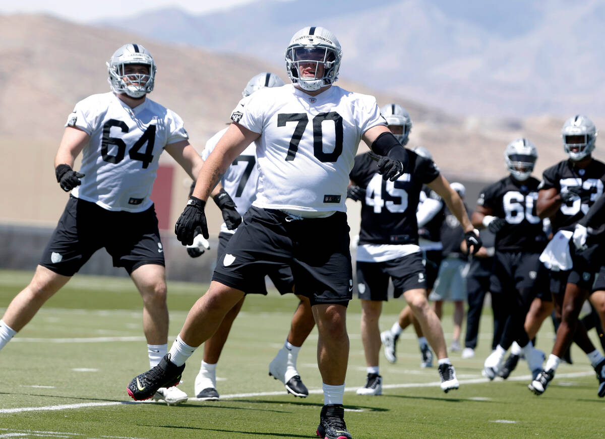 Raiders rookie guard Jackson Powers-Johnson (70) warms up during rookies first day of practice ...