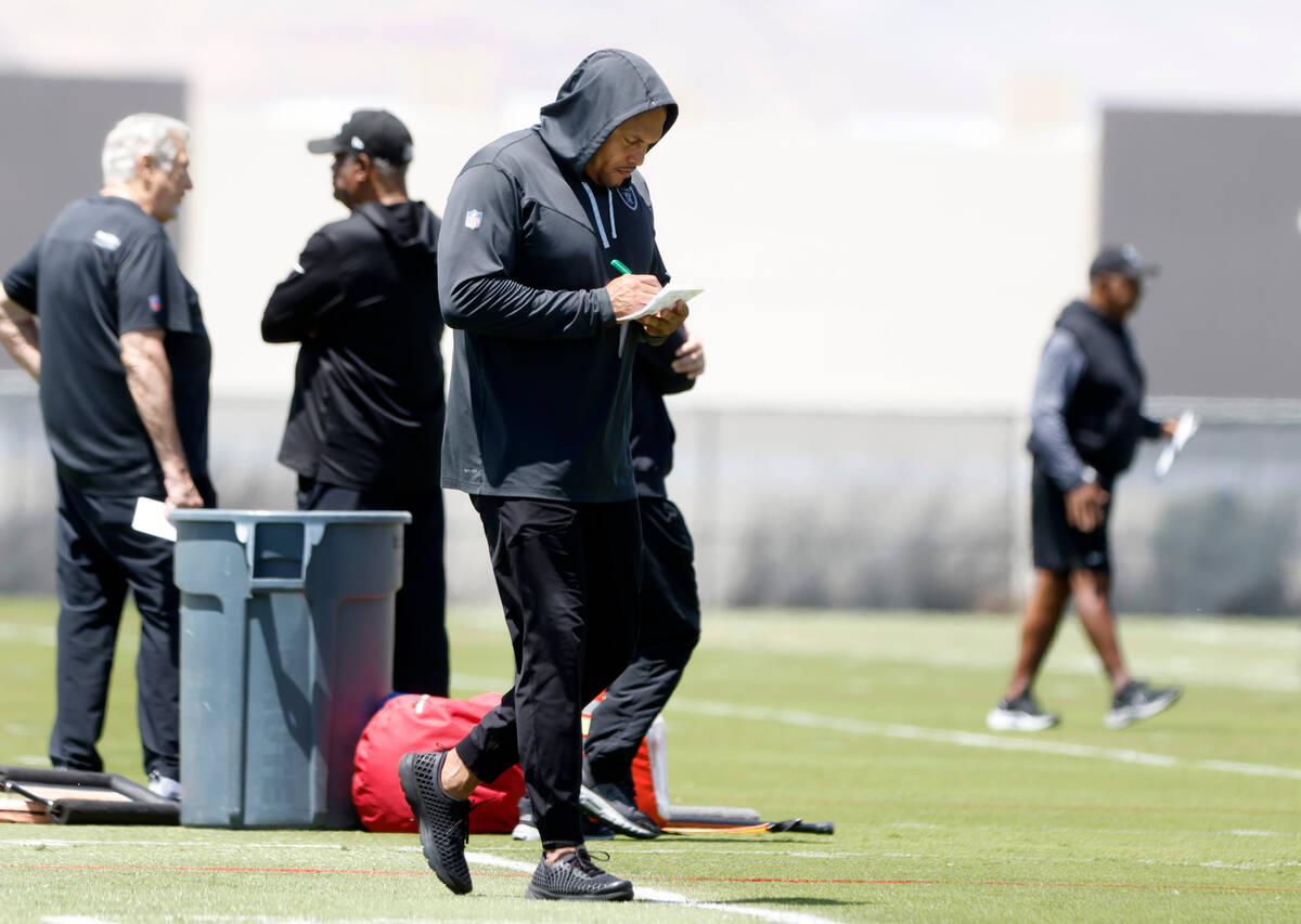 Raiders head coach Antonio Pierce takes notes as he watches his players during rookies first da ...