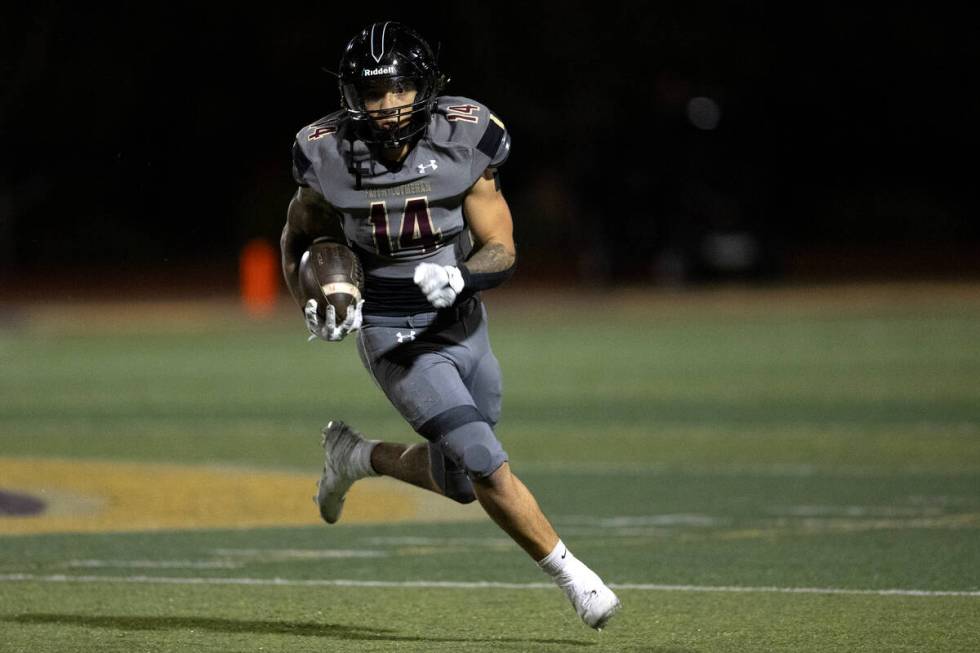 Faith Lutheran running back Cale Breslin (14) runs the ball during the first half of a high sch ...