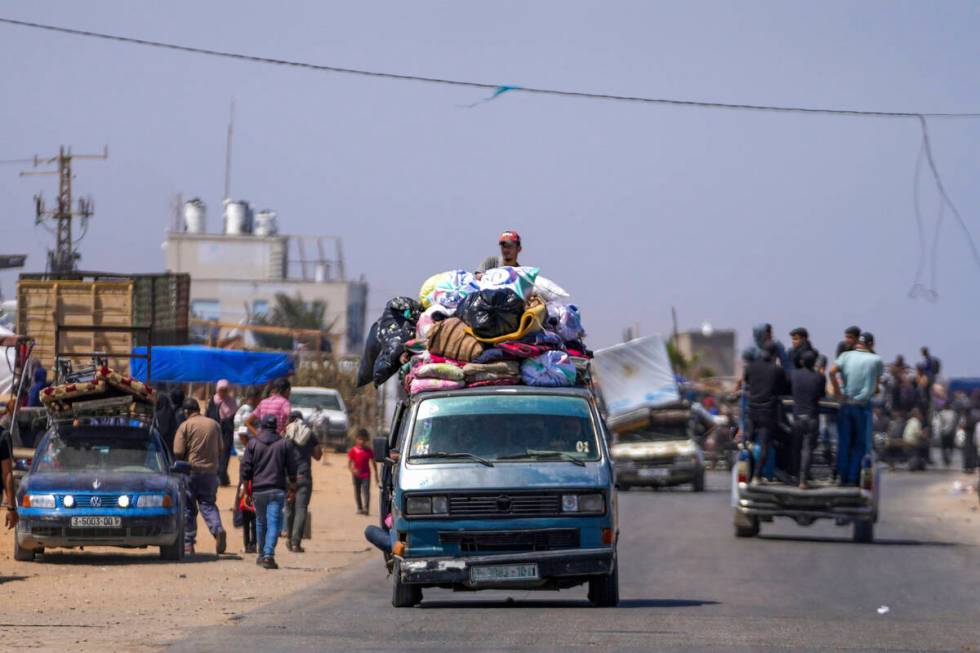 Displaced Palestinians arrive in central Gaza after fleeing from the southern Gaza city of Rafa ...