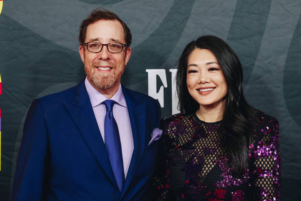 Rob Minkoff, left, and his wife, Crystal Minkoff pose for photographs on the red carpet at the ...