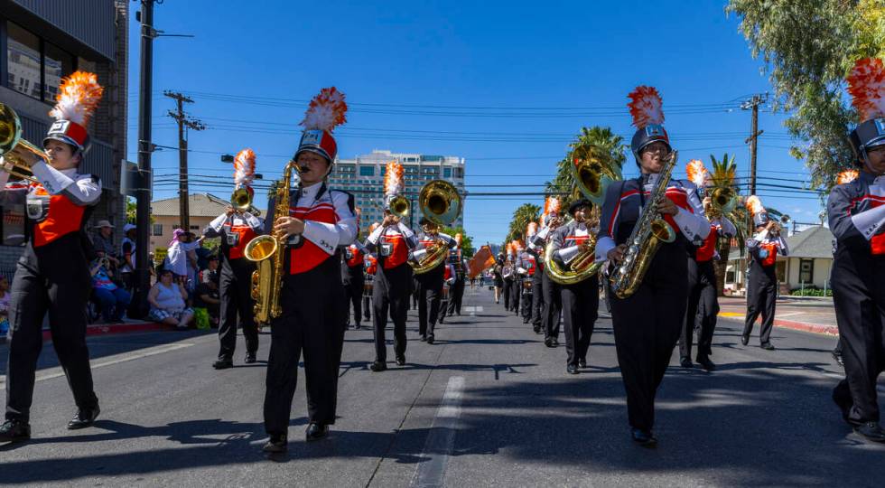 Members of the Chaparral High School marching band perform along the route during the Helldorad ...