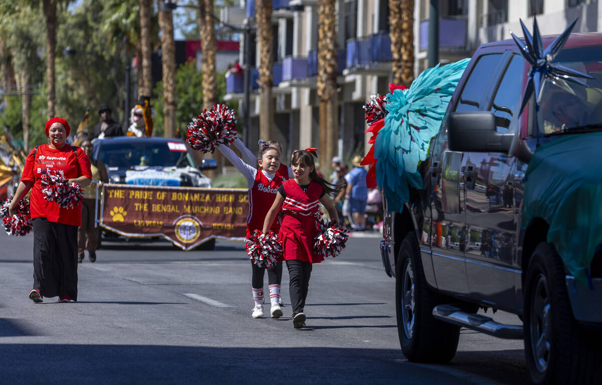 Cheerleads follow a Joven Progresa Foundation vehicle along the route during the Helldorado Par ...