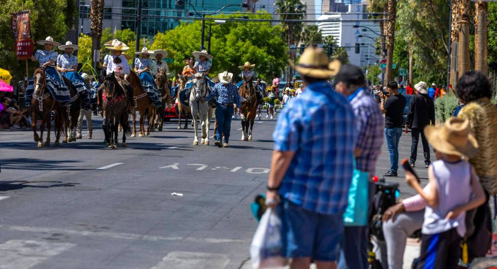 Members of the Escaramuza Charra of Nevada make their way on horseback along the route during t ...