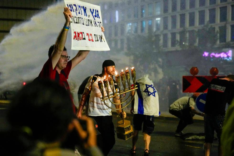 Police use water cannon to disperse demonstrators during a protest against Israeli Prime Minist ...