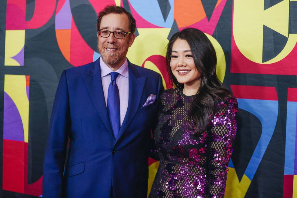 Rob Minkoff, left, and his wife, Crystal Minkoff pose for photographs on the red carpet at the ...