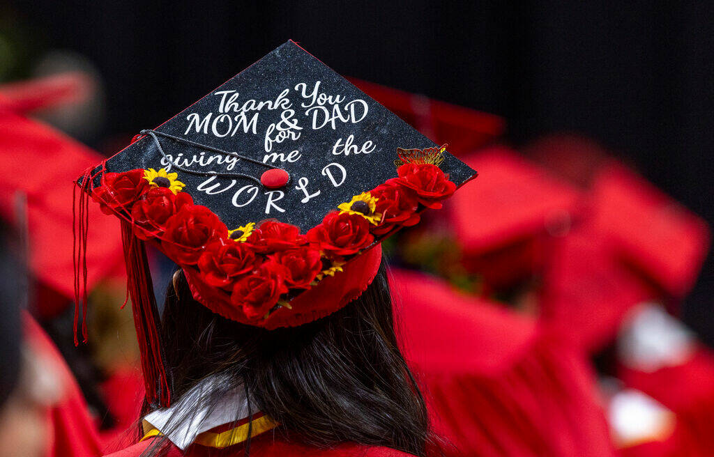 A graduate wears a custom mortar board during UNLV spring graduation commencement exercises at ...