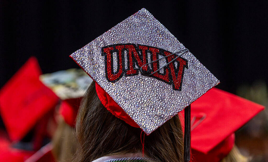 A graduate wears a custom mortar board during UNLV spring graduation commencement exercises at ...