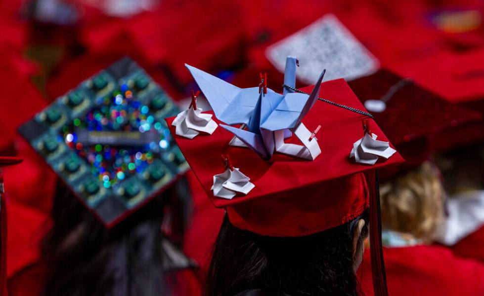 A graduate wears a custom mortar board during UNLV spring graduation commencement exercises at ...