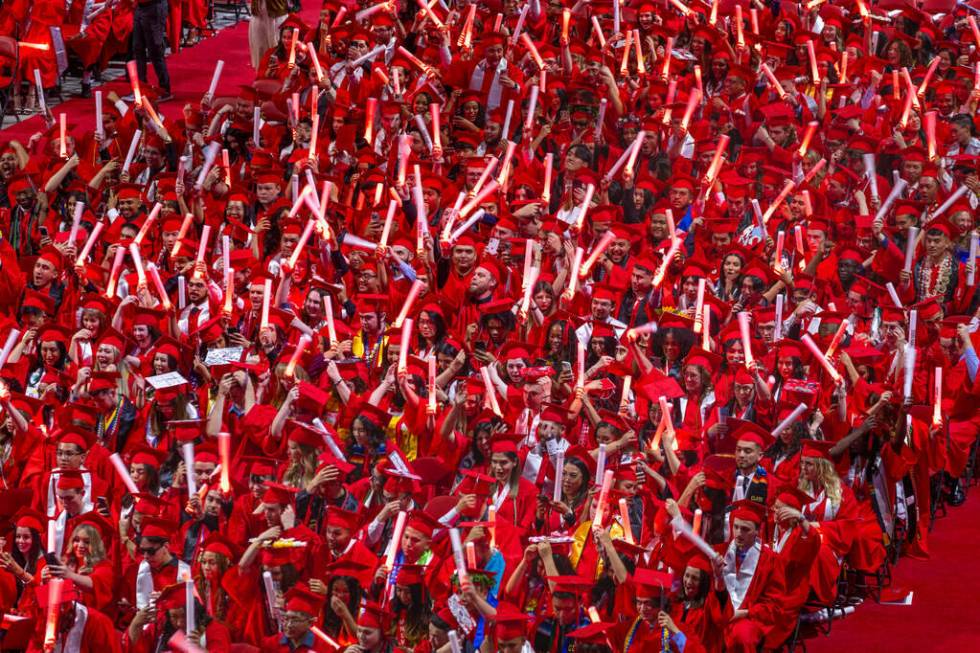 Graduates cheer and applaud by waving light sticks after the turning of their tassels during UN ...