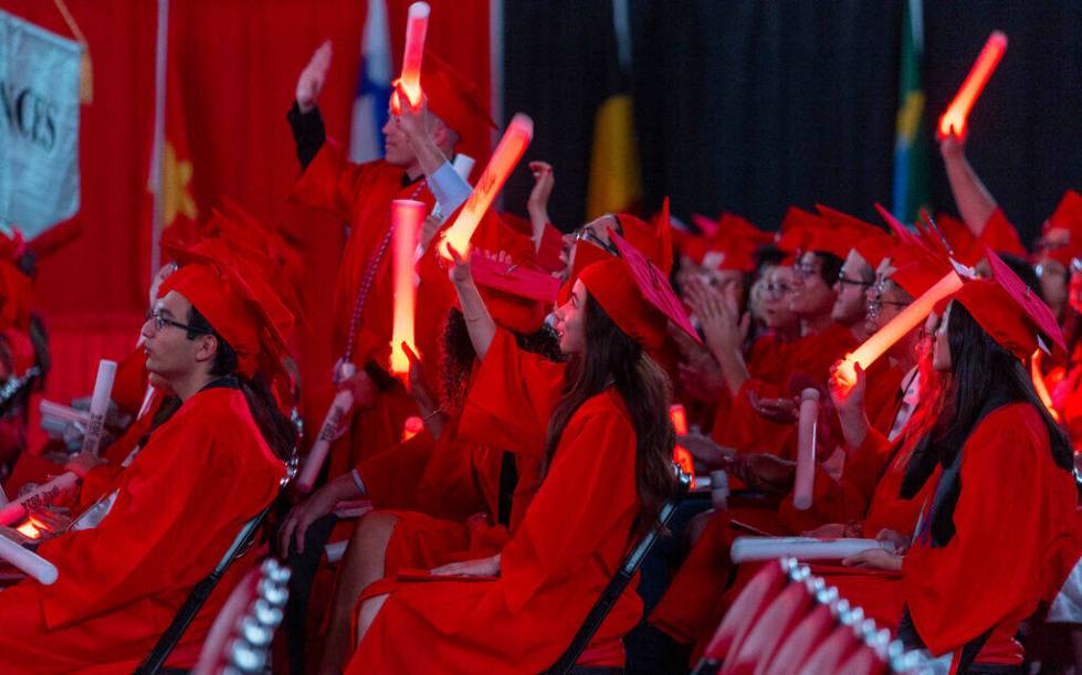 Graduates applaud by waving light sticks during UNLV spring graduation commencement exercises a ...