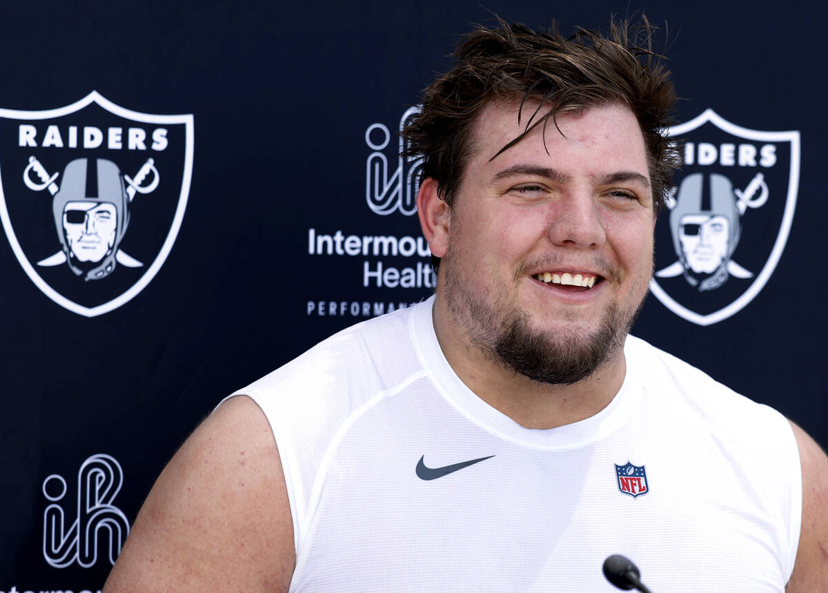 Raiders rookie guard Jackson Powers-Johnson smiles as he addresses the media after rookies firs ...