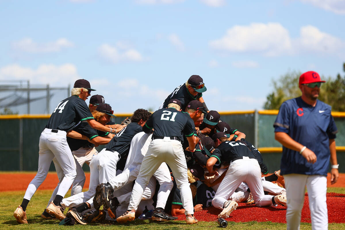 Coronado players dog piles on their pitcher after winning a Class 5A high school baseball South ...