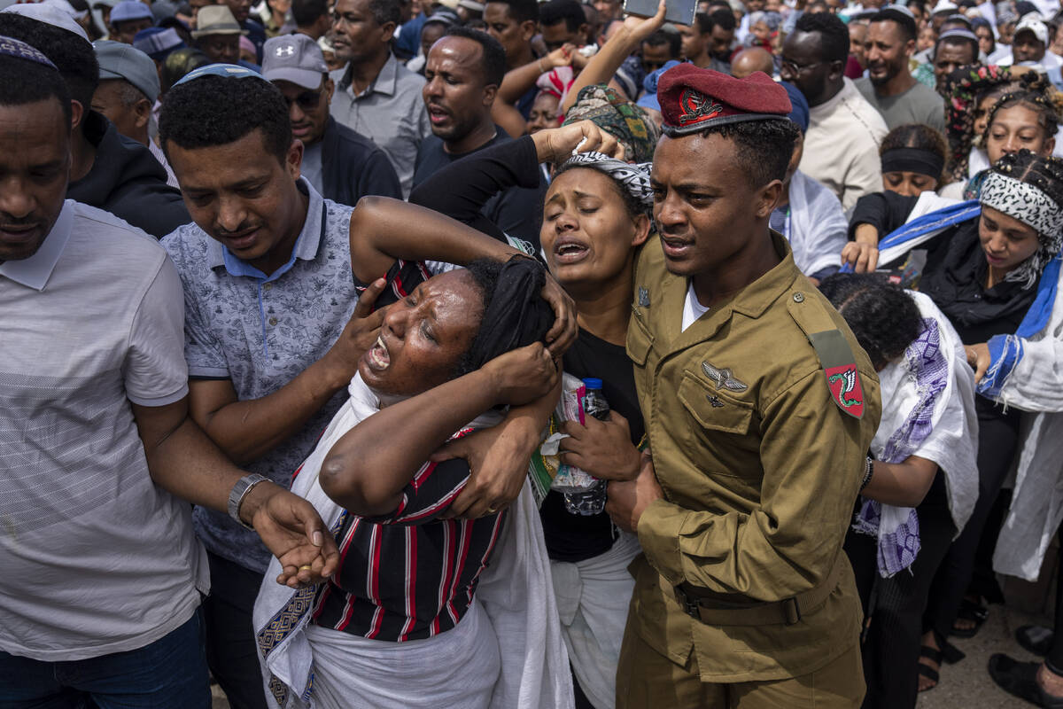 Family of Israeli solider Sergeant Yosef Dassa mourn in grief during his funeral in Kiryat Ata, ...