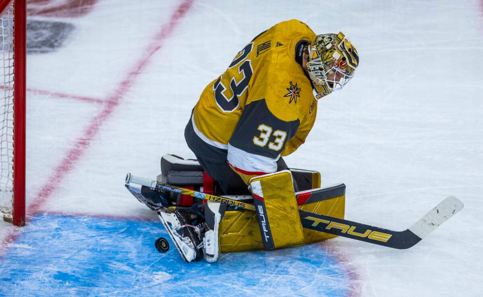 Golden Knights goaltender Adin Hill (33) deflects a shot off his skate against the Dallas Stars ...