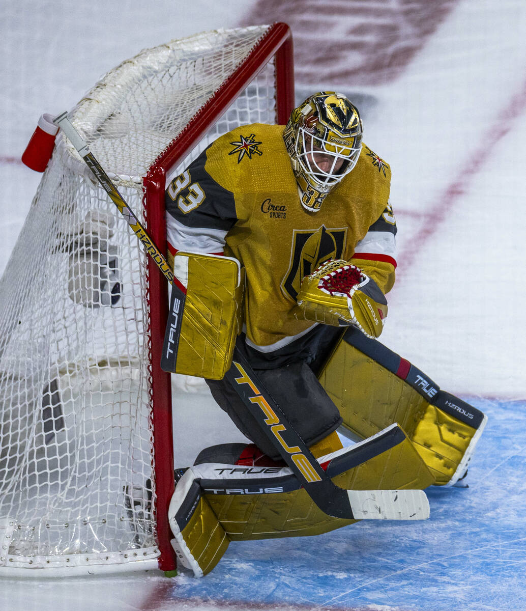 Golden Knights goaltender Adin Hill (33) curls up on a shot by the Dallas Stars during the seco ...