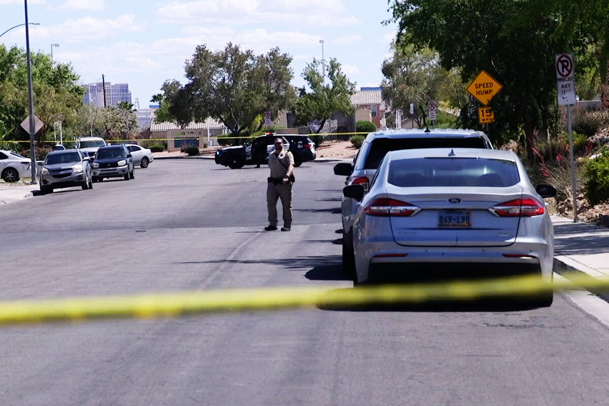 A Metro officer walks near a scene of a homicide investigation on the 2300 block of Goldhill Wa ...