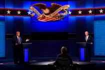 Moderator Chris Wallace of Fox News listens as Donald Trump and Joe Biden participate in the fi ...