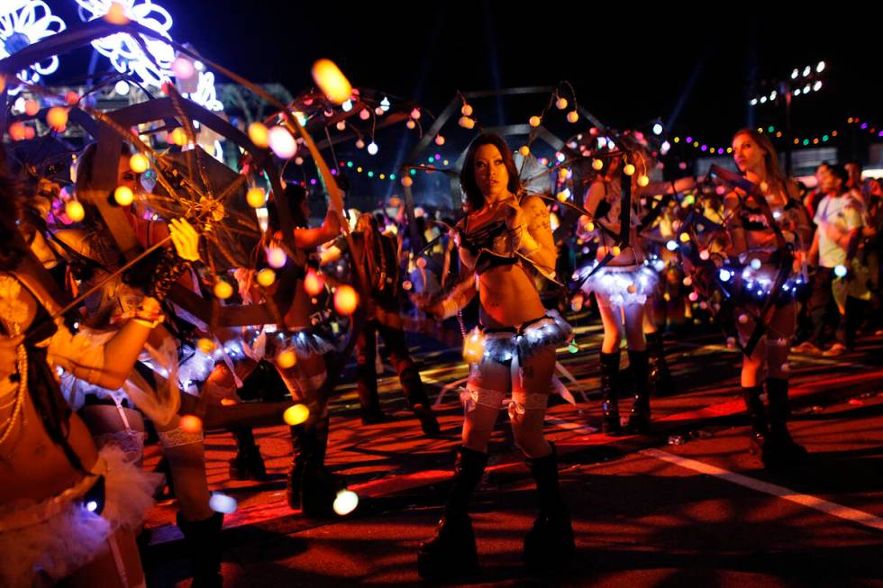 Performers walk around the Electric Daisy Carnival early in the morning of June 11, 2012. (John ...