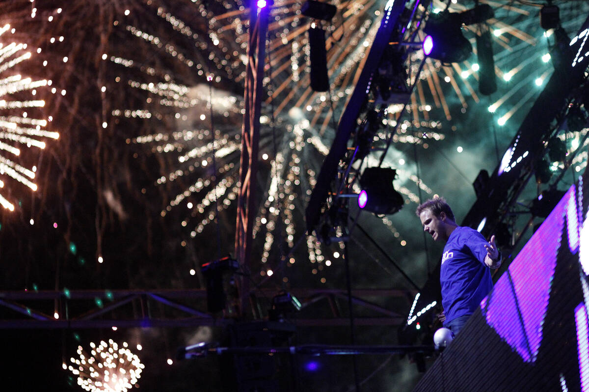 Dash Berlin performs as fireworks explode in the sky at the Electric Daisy Carnival early in th ...