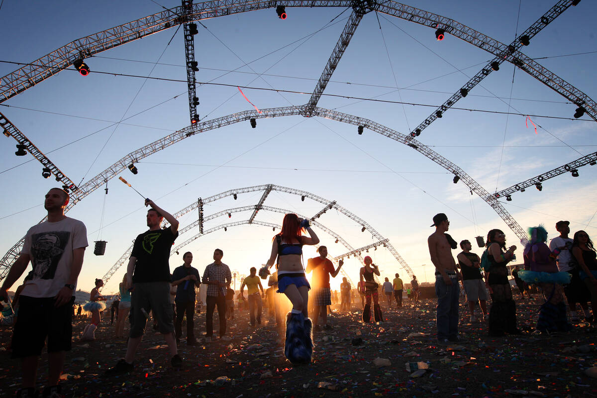 An unweary crowd keeps dancing despite the sunrise during the Electric Daisy Carnival at the La ...