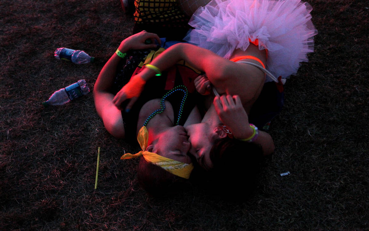 A Las Vegas couple shares a kiss at the cosmicMEADOW during the Electric Daisy Carnival at the ...