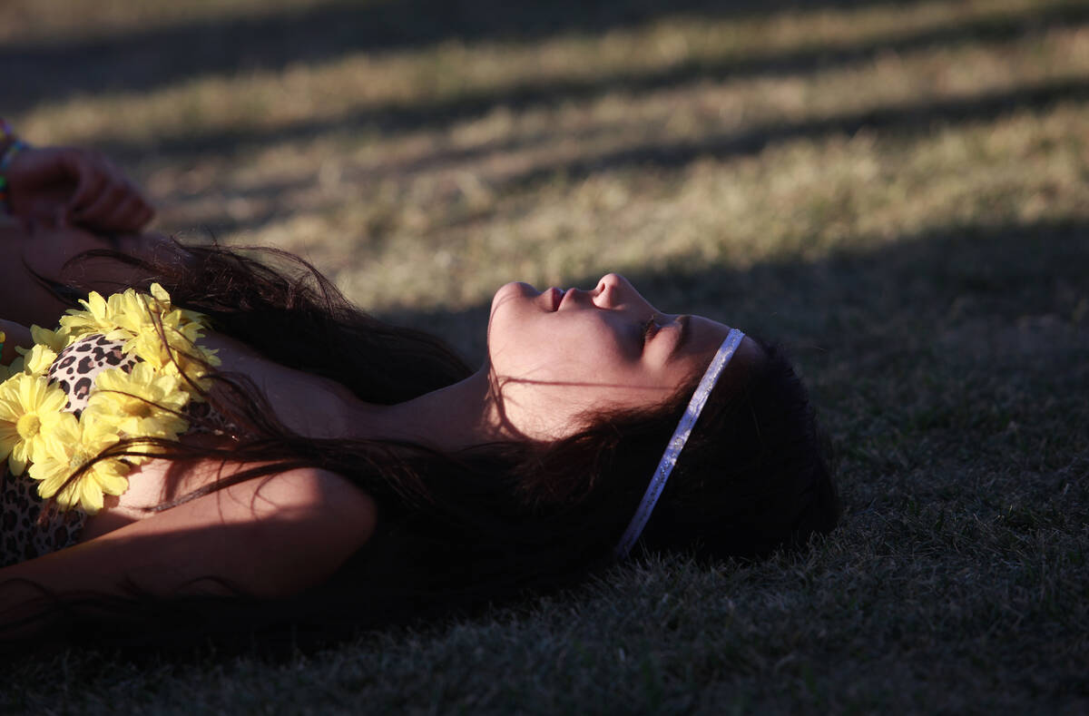 A woman rests before the festival closes for the day the Electric Daisy Carnival at the Las Veg ...