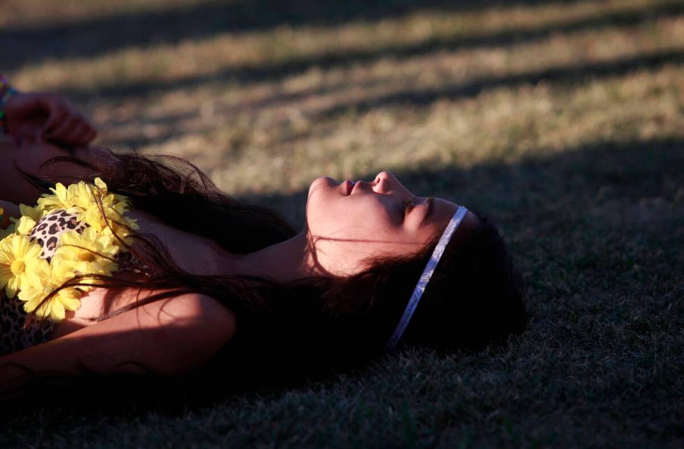 A woman rests before the festival closes for the day the Electric Daisy Carnival at the Las Veg ...