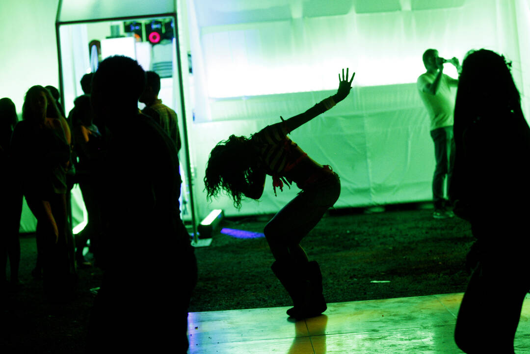 Kiearah Figueroa of Las Vegas, center, dances outside the Sony booth during third night of the ...