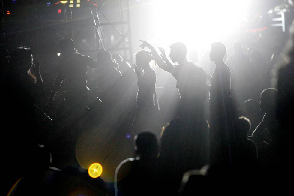 Revelers make their way through the crowd at the Electric Daisy Carnival at the Las Vegas Motor ...