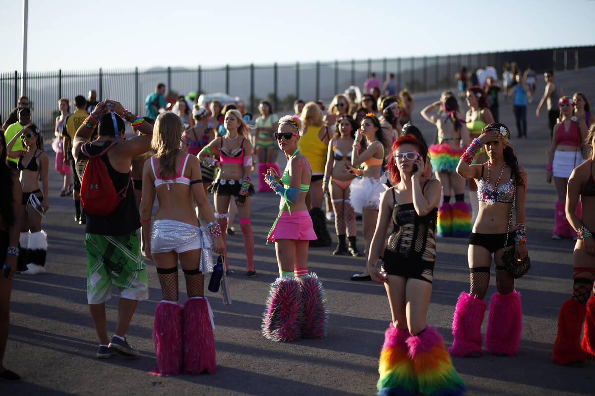 Ashlie Sandoval, center, and other women wait for friends at an entrance to the Electric Daisy ...