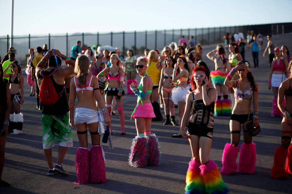 Ashlie Sandoval, center, and other women wait for friends at an entrance to the Electric Daisy ...