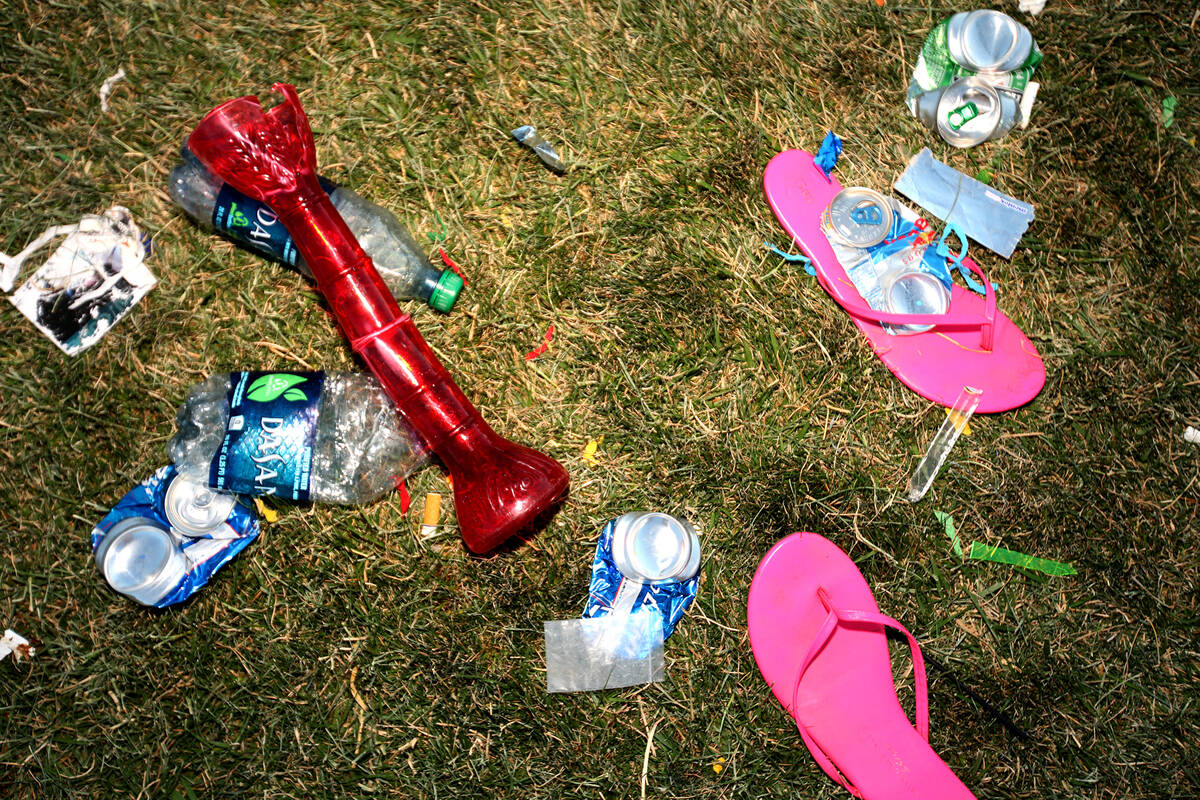 Discarded alcohol containers and flip-flops are left behind on the first night of the Electric ...
