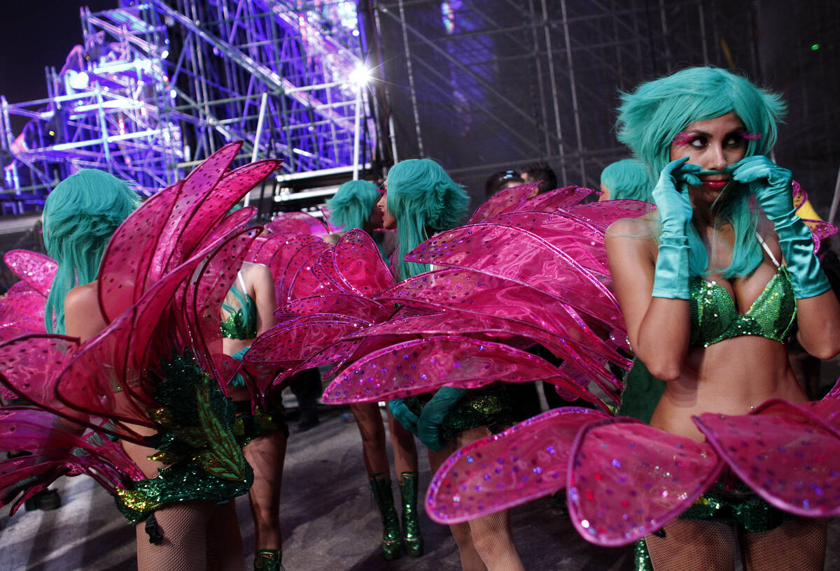 Dancers with the Flower Brigade wait backstage between performances during the Electric Daisy C ...