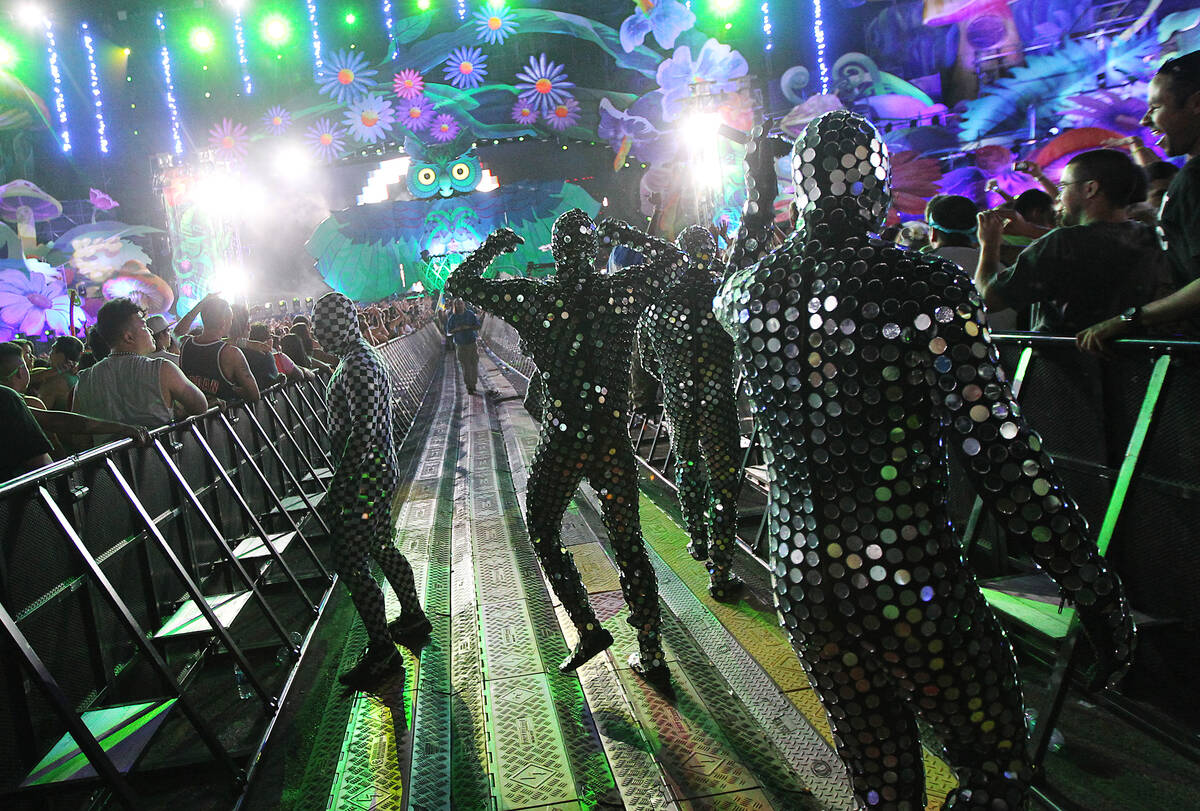 Men in mirror suits entertain the crowd during Insomniac's Electric Daisy Carnival at the Las V ...