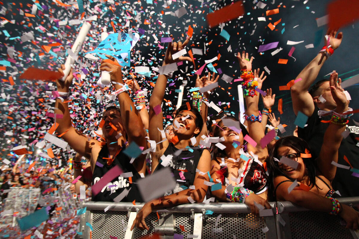 Festival-goers watch Steve Angello at Kinetic Field as confetti goes off at the Electric Daisy ...