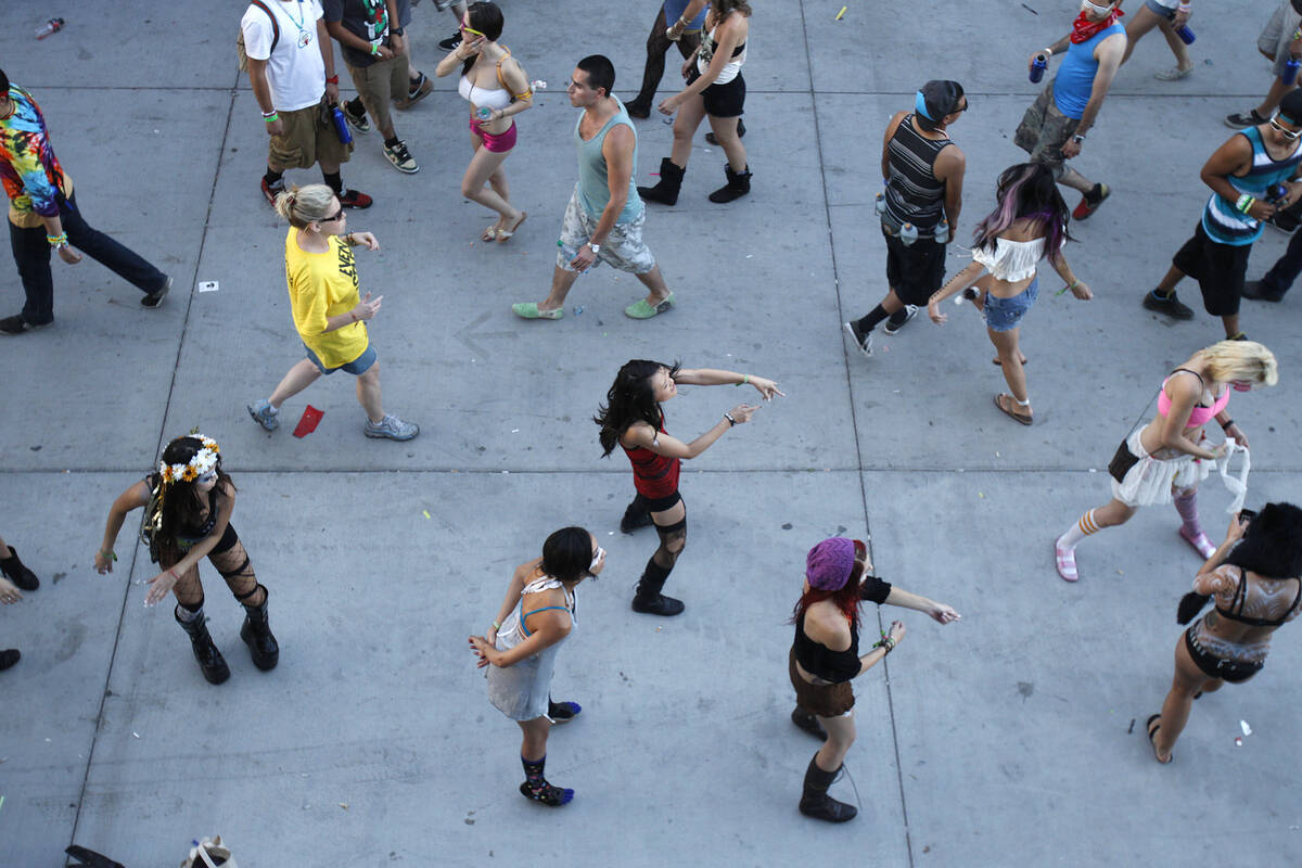 People dance as day breaks at the Electric Daisy Carnival at the Las Vegas Motor Speedway on Su ...