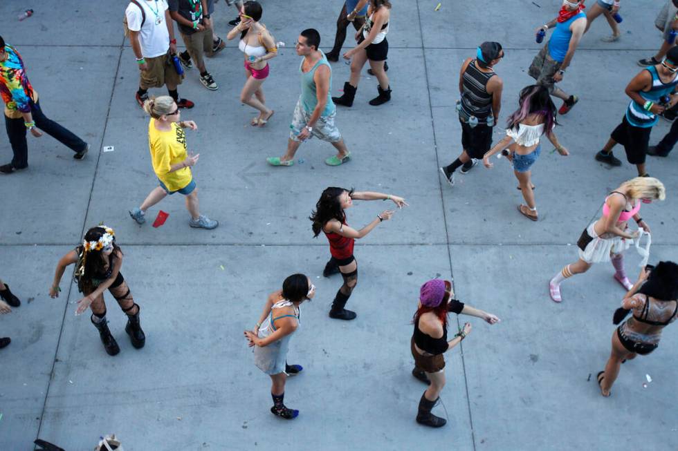 People dance as day breaks at the Electric Daisy Carnival at the Las Vegas Motor Speedway on Su ...