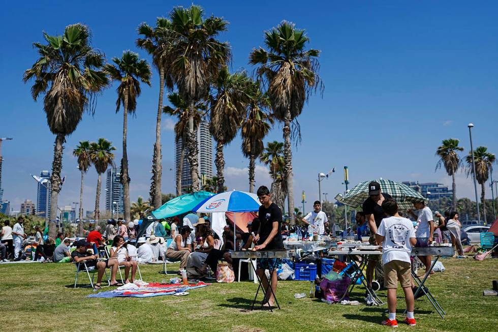 People prepare their food on a grill as they spend the day on a park during Israel's Independen ...