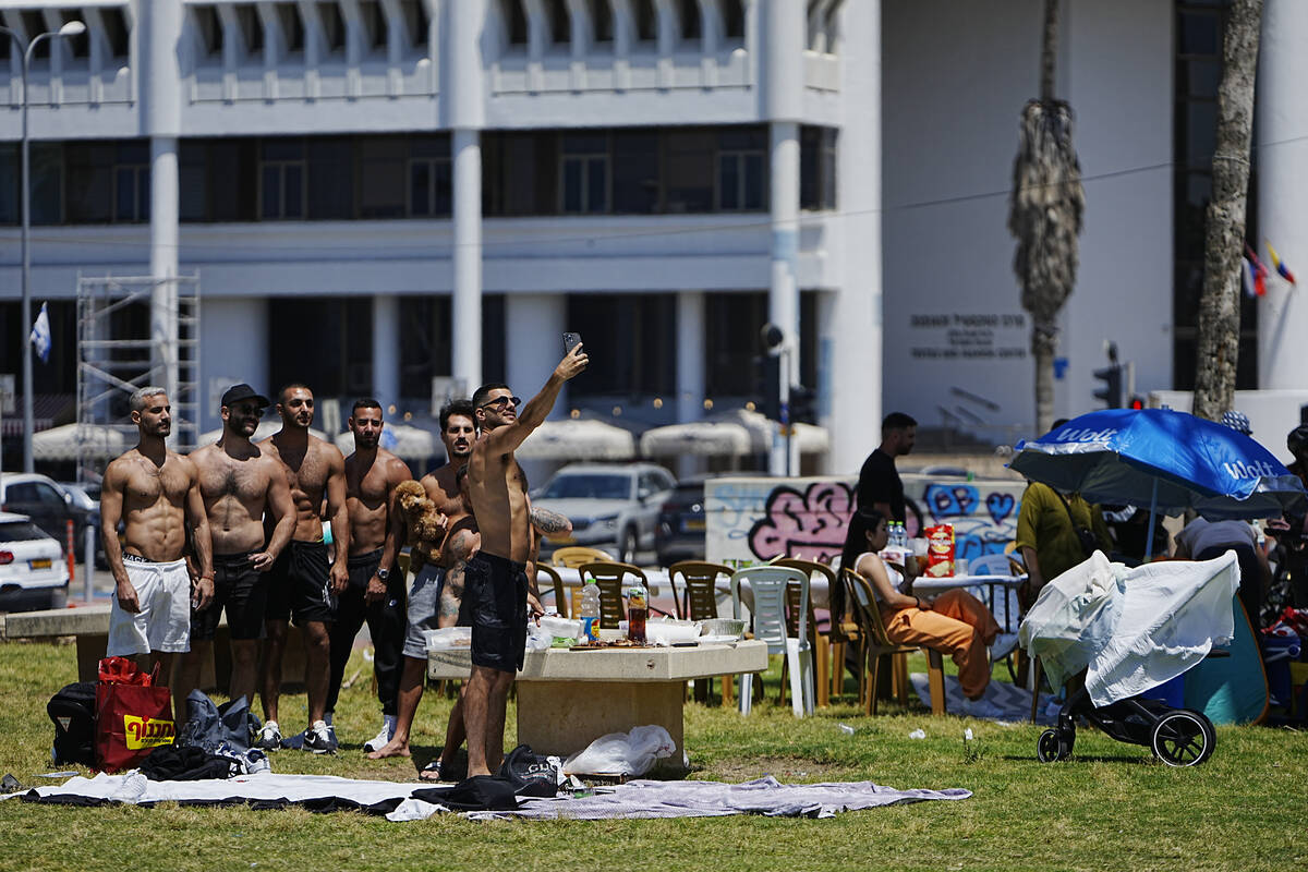 People pose for a selfie in a park during Israel's Independence Day celebrations in Tel Aviv, T ...