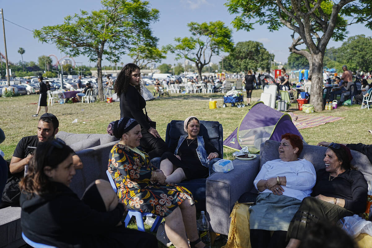 People talk as they sit on sofas during Israel's Independence Day celebrations at a park in Tel ...