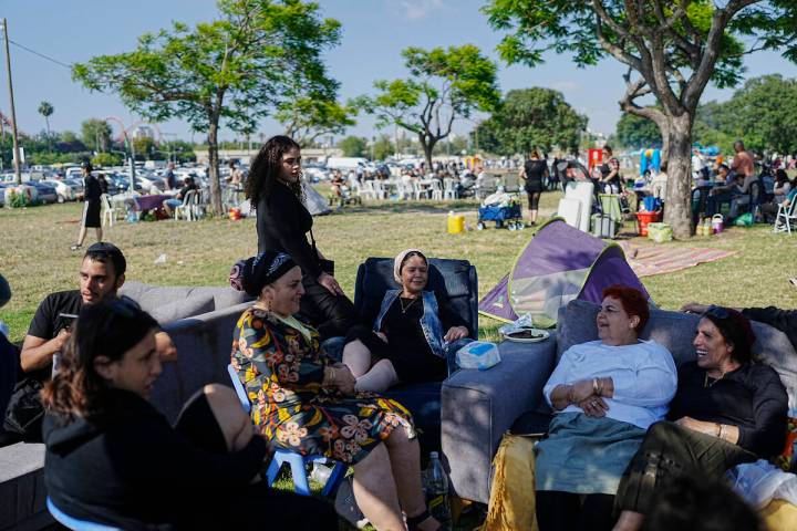 People talk as they sit on sofas during Israel's Independence Day celebrations at a park in Tel ...