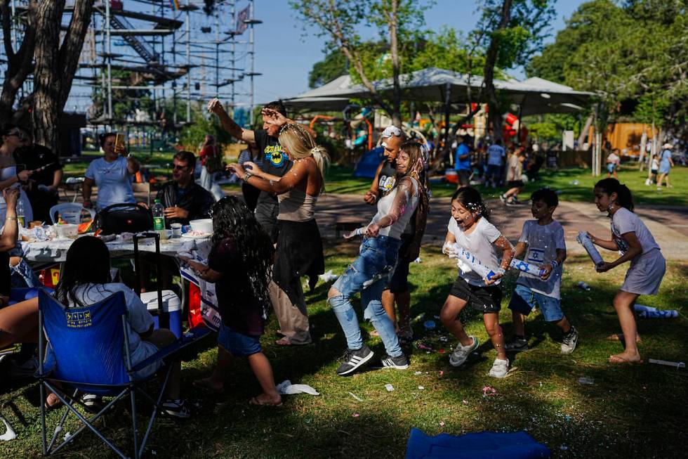 Children joke around as they spend the day during Israel's Independence Day celebrations, at a ...