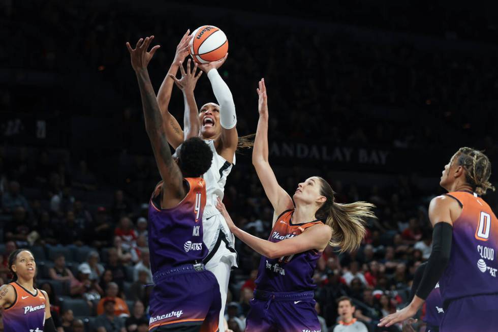 Las Vegas Aces center A'ja Wilson (22) shoots over Phoenix Mercury forward Natasha Mack (4) and ...