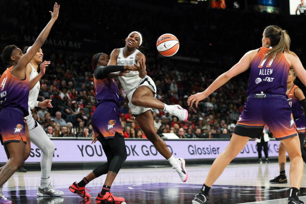 Las Vegas Aces guard Jackie Young (0) is fouled by Phoenix Mercury guard Kahleah Copper (2) dur ...