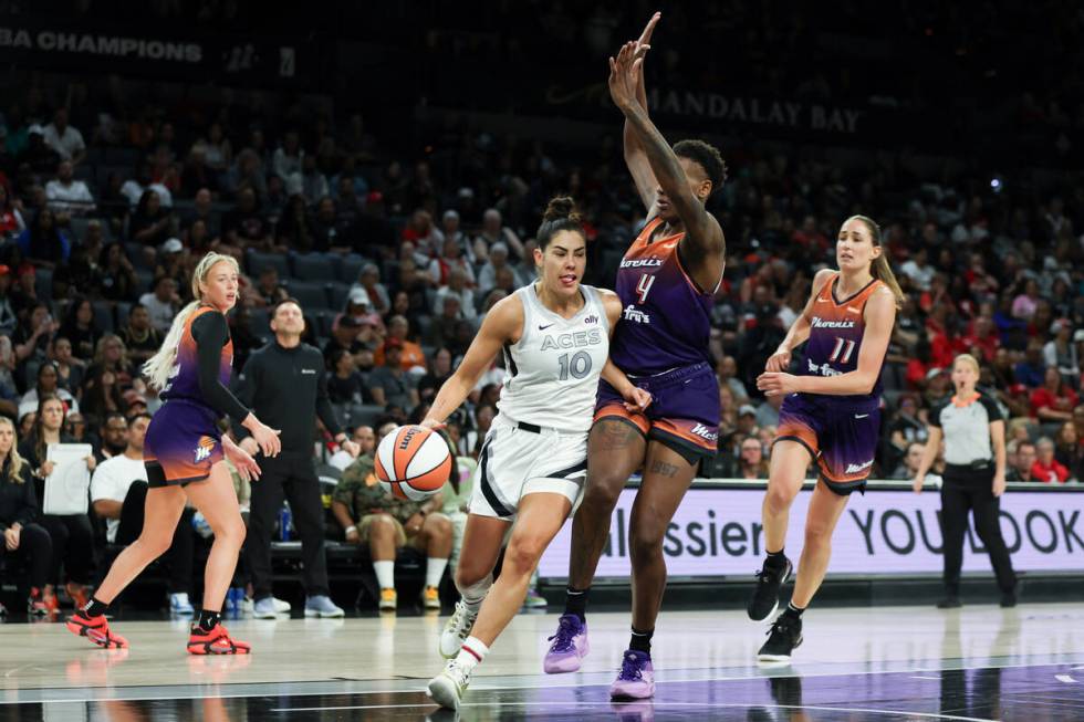 Las Vegas Aces guard Kelsey Plum (10) drives toward the hoop against Phoenix Mercury forward Na ...