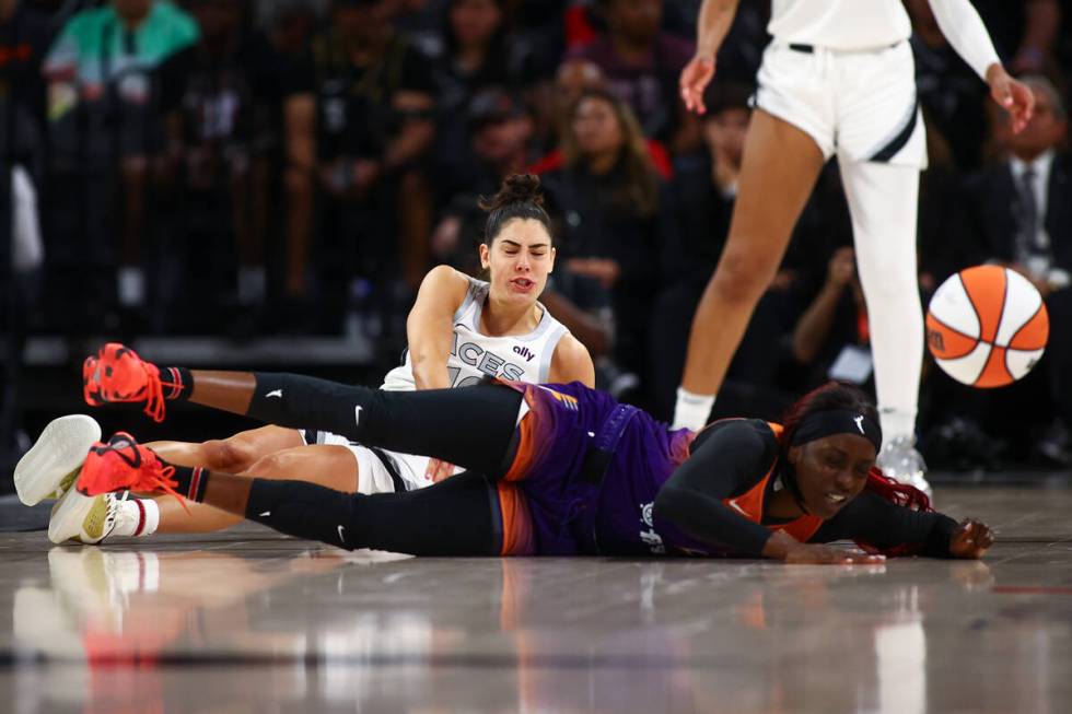 Las Vegas Aces guard Kelsey Plum (10) and Phoenix Mercury guard Kahleah Copper (2) fall to the ...