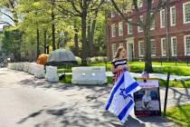 Rotem Spiegler, an alumni of Harvard University, stands near an encampment set up at the univer ...